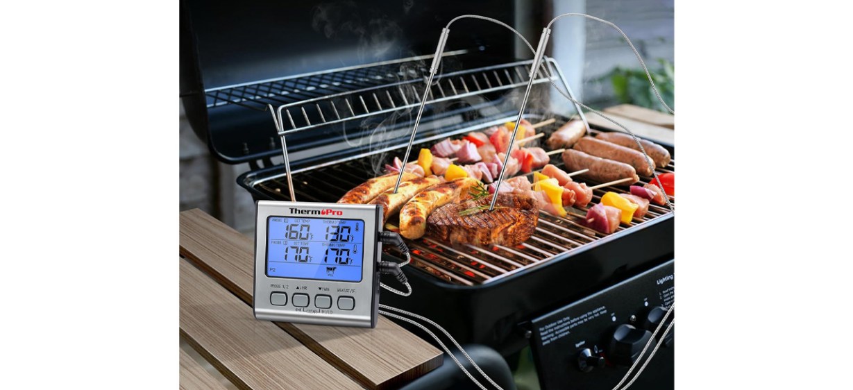 ThermoPro TP-17 Dual Probe Digital Cooking Meat Thermometer next to meat on grill ThermoPro TP-17 Dual Probe Digital Cooking Meat Thermometer next to meat on grill