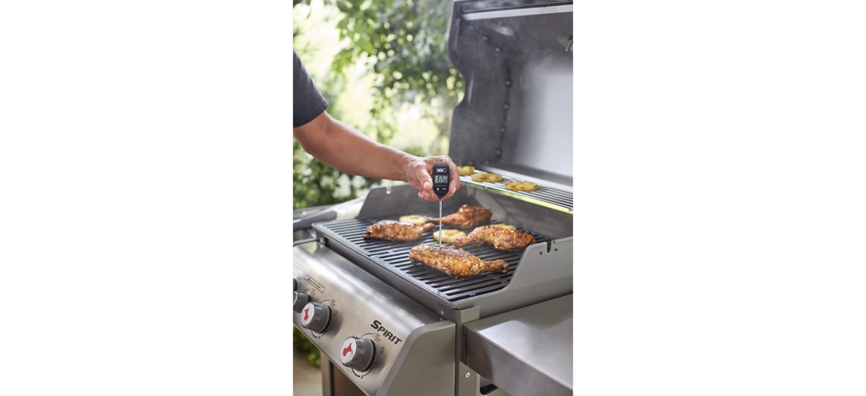 Person using Weber Instant Read Meat Thermometer on grill Person using Weber Instant Read Meat Thermometer on grill