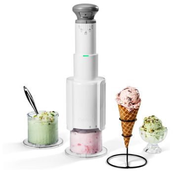 white and grey ice cream maker with one cone and two dishes of ice cream next to it