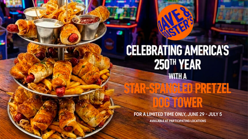 Promotional graphic for Dave & Buster's featuring a three-tier tower stacked with pretzel-wrapped hot dogs, fries, onion rings, and dipping sauces in an arcade setting. Text announces: "Celebrating America's 250th Year with a Star-Spangled Pretzel Dog Tower," available June 29–July 5 at participating locations.