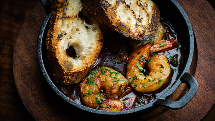 Gambas al ajillo with poached shrimp, sherry vinegar, garlic, smoked paprika and grilled bread at The Pawn Shop in San Francisco.