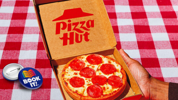 Pizza Hut personal pan pizza on a red-checkered tablecloth with a BOOK IT! pin