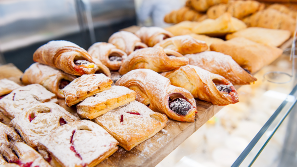 Danishes and other baked goods in a bakery window