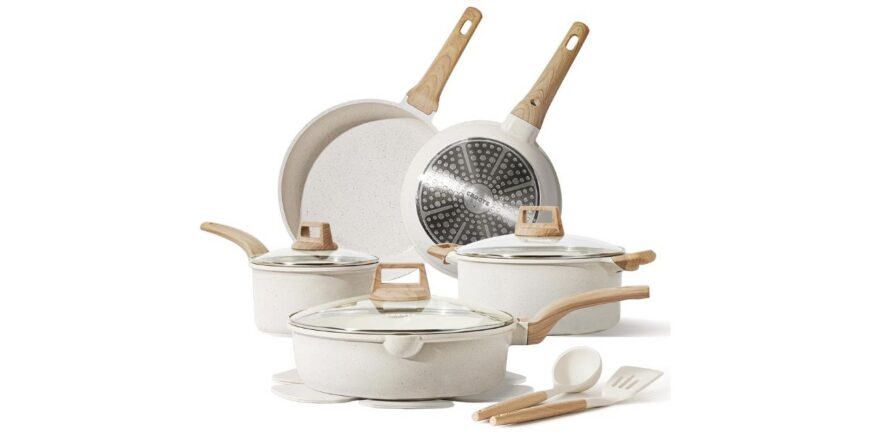 set of five cream-colored pots and pans with lids and spatulas on a white background