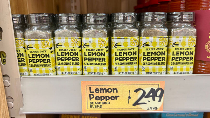 Trader Joe's Lemon Pepper Seasoning Blend in 2.5-ounce spice bottles lined up on a shelf, with a price tag showing $2.49.