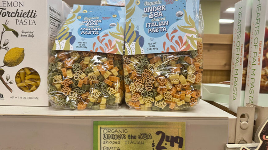 Two bags of Trader Joe’s Organic Under the Sea Shaped Italian Pasta, featuring colorful sea-themed pasta shapes in blue, green, orange, and yellow.