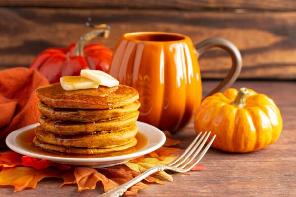 A Stack of Pumpkin Spice Flavored Pancakes on a Wooden Table