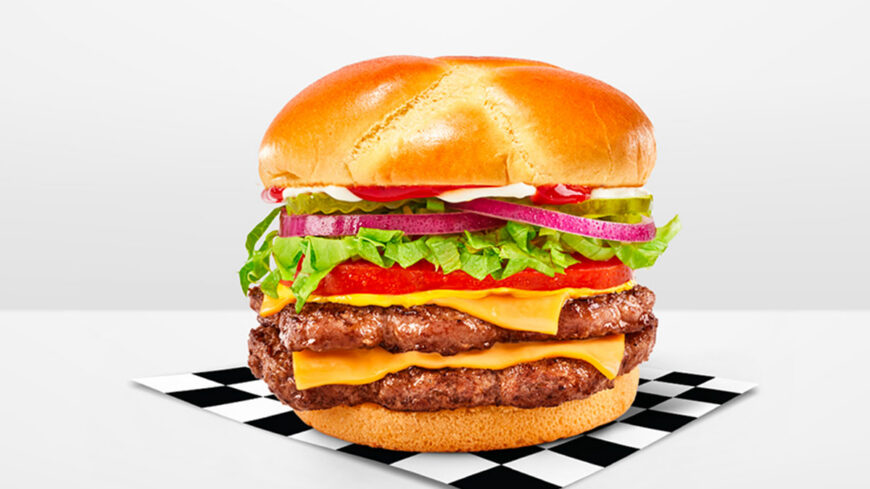 Double cheeseburger with two beef patties, melted American cheese, lettuce, tomato, pickles, and onions on a toasted bun.