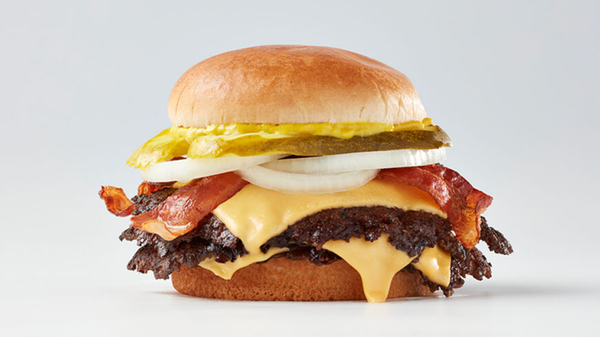 Triple-patty cheeseburger with crispy bacon, melted American cheese, lettuce, pickles, sliced onions, mustard, and a toasted bun.