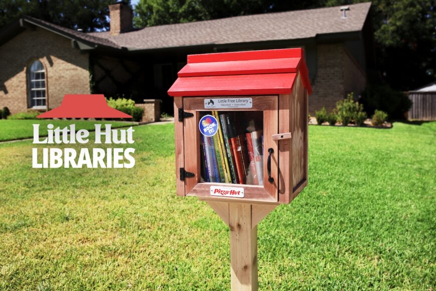 Pizza Hut's little free library in a yard with a house in the background