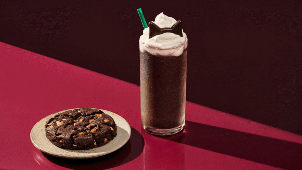 Starbucks Black Cat Frappuccino Blended Beverage sitting on a red table