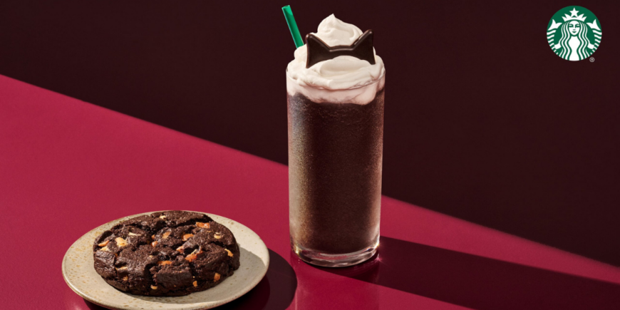 Starbucks Black Cat Frappuccino Blended Beverage sitting on a red table