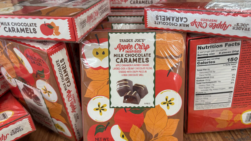 A package of Trader Joe’s Apple Crisp–inspired Milk Chocolate Caramels, featuring apple and fall-leaf illustrations. The package contains 10 pieces of milk chocolate filled with apple-cinnamon caramel.