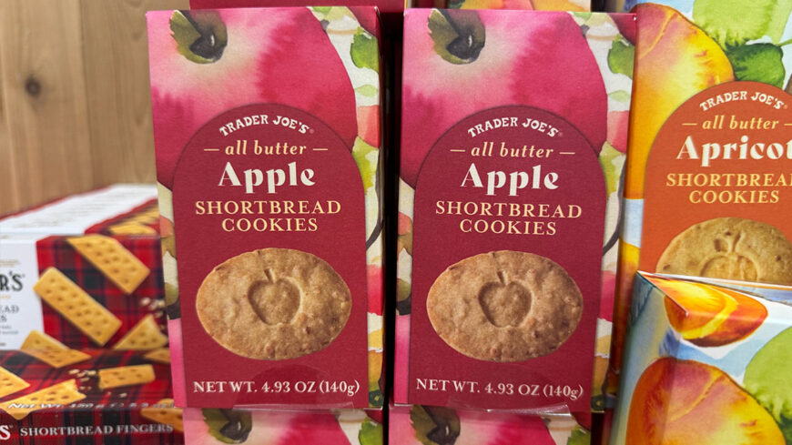 Trader Joe’s all-butter Apple Shortbread Cookies in red boxes, featuring an apple-shaped cookie and colorful fruit artwork.