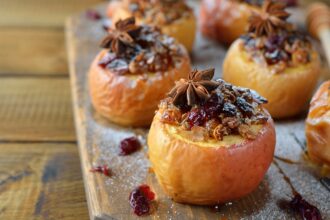 Baked apples with spices on a brown background