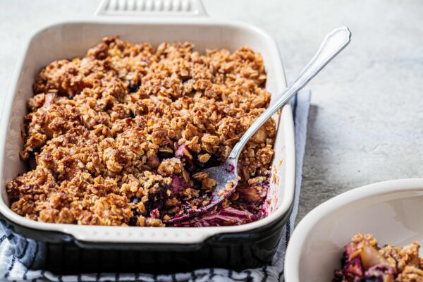 Homemade berry oat crumble pie in a backing dish. Comfort food concept.