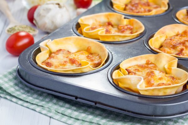 Homemade lasagna cups with minced meat, bolognese sauce topped with cheese