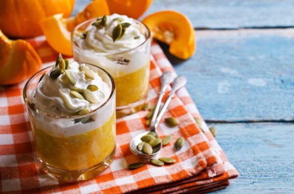 Dessert from the pumpkin and seeds with whipped cream. Selective focus.