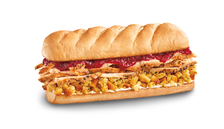 Sub sandwich filled with sliced turkey, savory stuffing, creamy mayonnaise and cranberry sauce on a toasted roll.