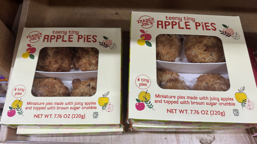 Two boxes of Trader Joe’s Teeny Tiny Apple Pies, each containing four miniature apple pies topped with brown sugar crumble.