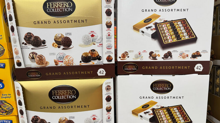 Stacks of Ferrero Collection Grand Assortment chocolate boxes containing assorted Ferrero Rocher, Rondnoir, Raffaello, and other chocolates.