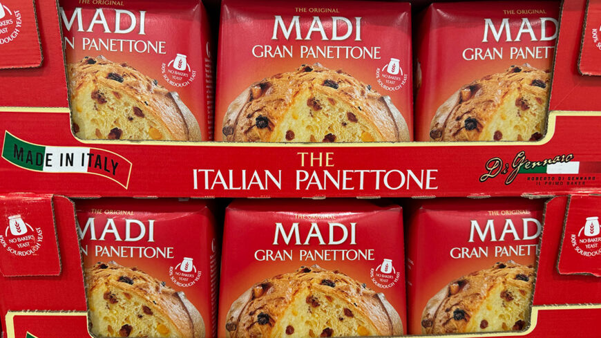 Boxes of Madi Gran Panettone, an Italian sweet bread with raisins and candied fruit, displayed in red packaging.