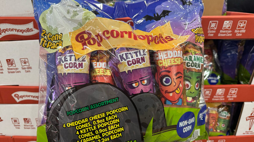 A package of assorted flavored popcorn cones, including cheddar cheese, kettle corn, and caramel corn, displayed on a store shelf.